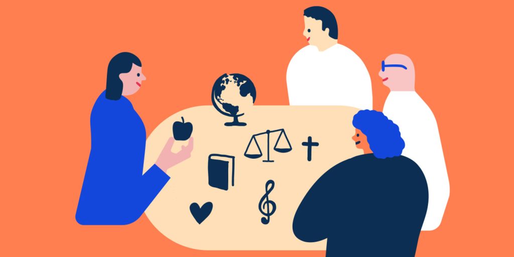 En grupp människor som sitter runt ett bord.