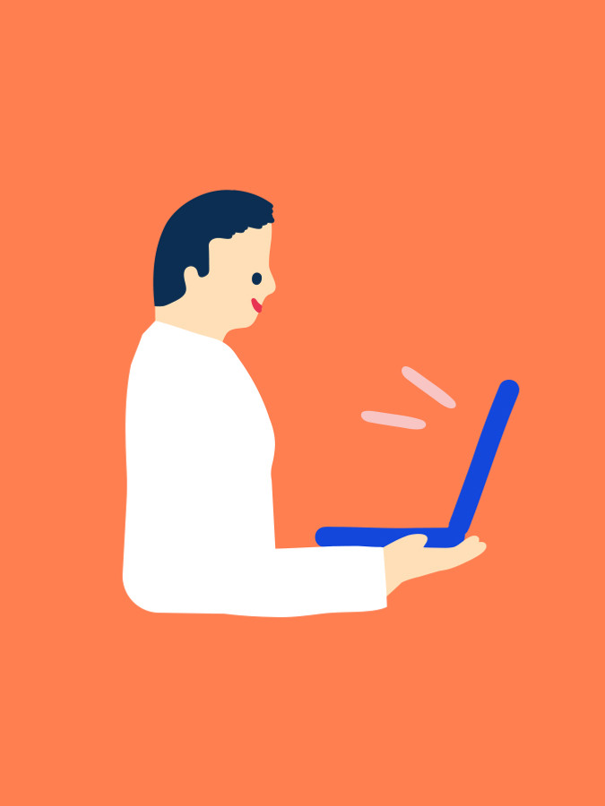 En man använder en bärbar dator på en orange bakgrund.