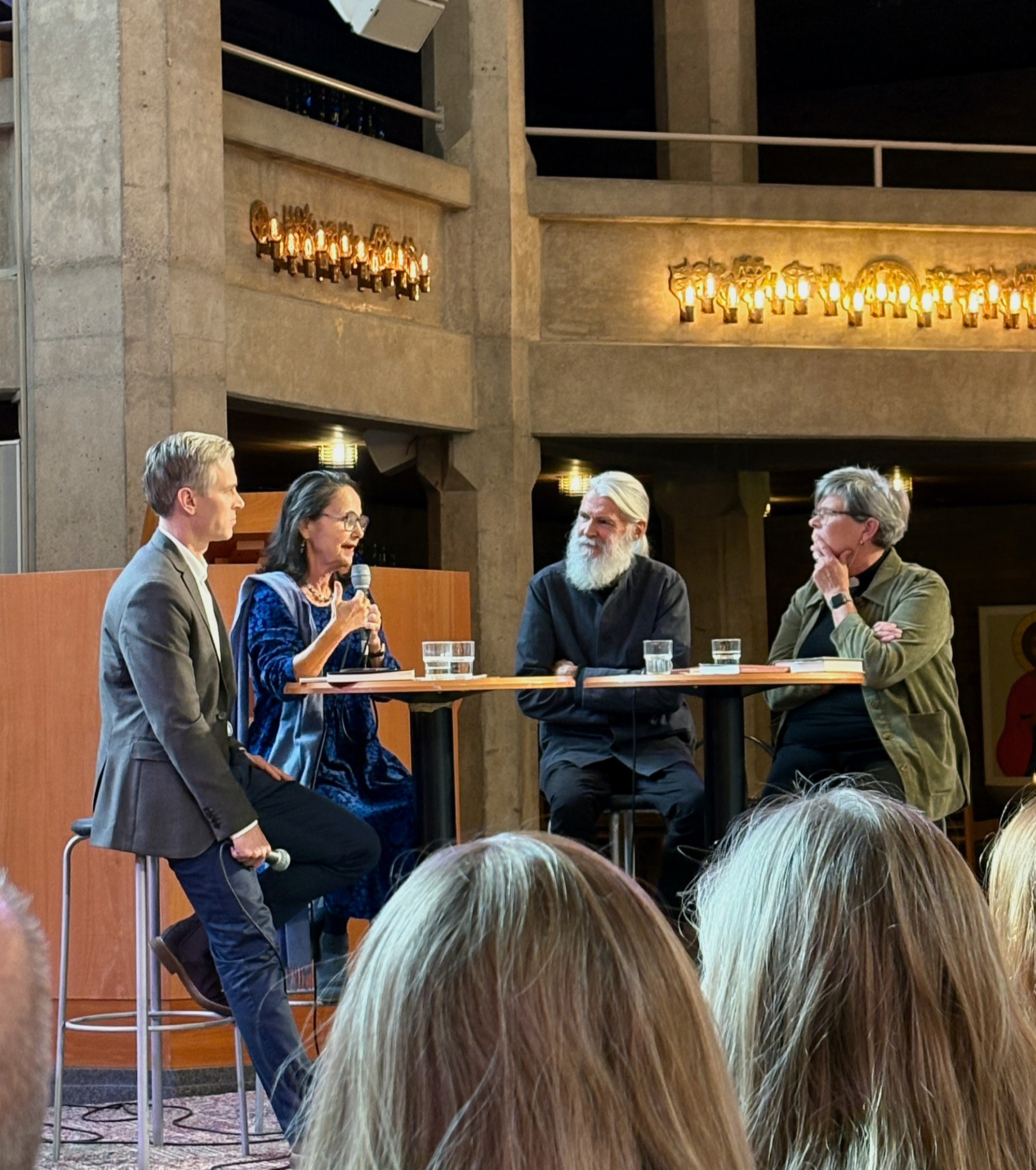 Fyra personer som sitter på en scen och deltar i en paneldiskussion.